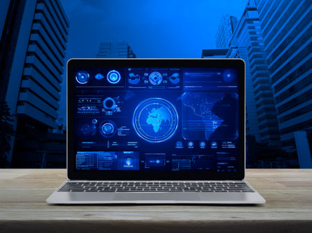 Laptop computer with digital world map with data charts and stats screen on wooden table over office city tower and skyscraper, Futuristic user interface technology online concept, Generative AIの素材