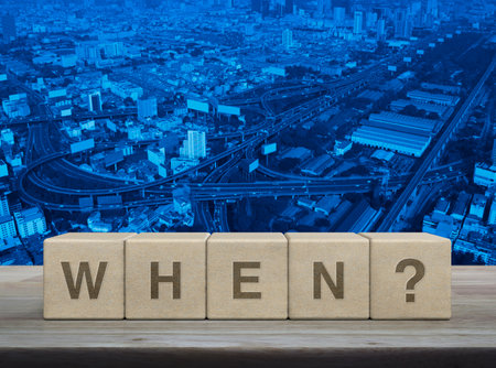 When letter on wood block cubes on wooden table over modern city tower, street, expressway and skyscraper, Business communication conceptの写真素材