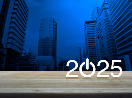 2025 start up business flat icon on wooden table over modern office city tower and skyscraper, Happy new year 2025 success conceptの写真素材