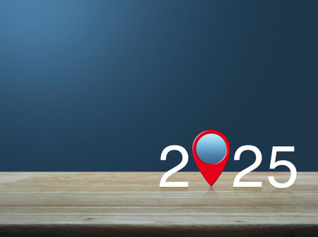 2025 letter with map pin location icon on wooden table over light blue wall, Happy new year 2025 map...