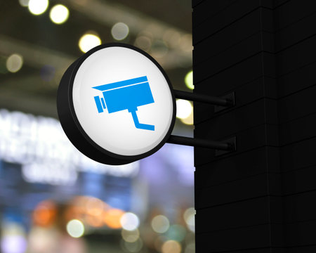 Cctv camera icon on hanging black rounded signboard over blur light and shadow of shopping mall, Technology security and safety online concept, 3D renderingの写真素材