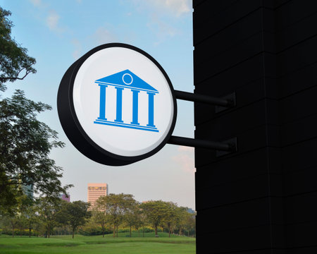 Bank icon on hanging black rounded signboard over green grass field and trees in park, Business banking online service concept, 3D renderingの写真素材