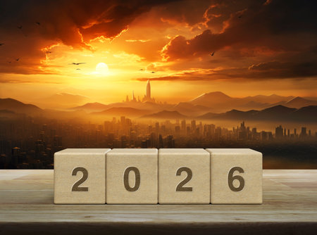 2026 letter on wood block cubes on wooden table over aerial panoramic view of city tower and mountain at golden hour, Happy new year 2026 cover concept, Generative AIの素材