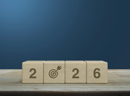 letter with goal flat icon on wood block cubes on wooden table over light blue wall, Happy new year...
