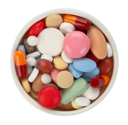Colored pills in white bowl - top viewの写真素材