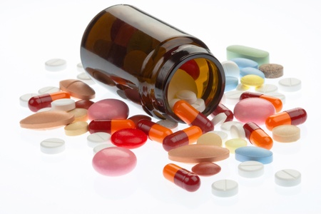 Pills pouring out of the brown bottleの写真素材