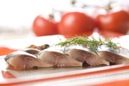 Four herring slices with tomato background の写真素材