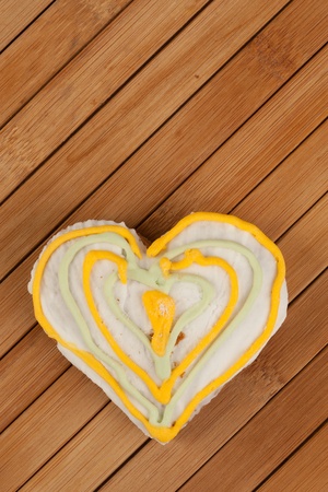 Gingerbread heart on a wooden padの写真素材