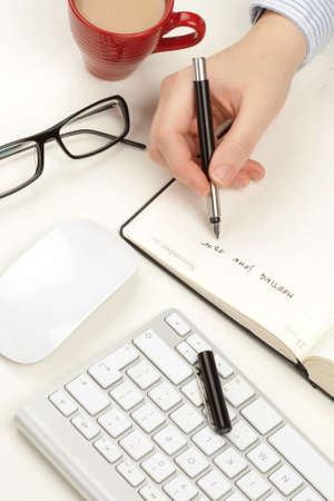 Woman s hand writes in a notebookの写真素材