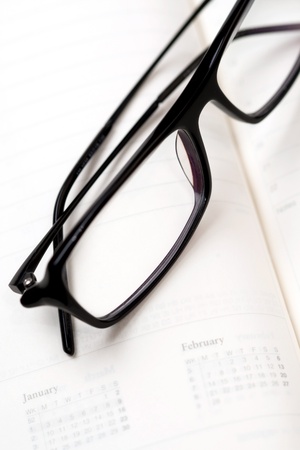 Glasses and paper notebookの写真素材