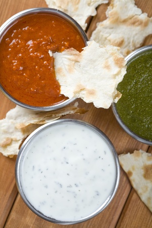 Mint chutney, mint yogurt and spicy pepper dip. White, green and red. の写真素材