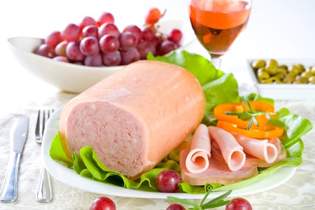 Luncheon meat, salad, olives and grapes の写真素材