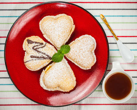Vanilla heart on a red plate 