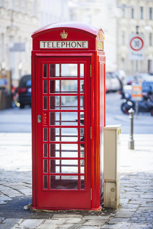 Old english style, red public phone on one of the streets of Vienna, Austria  の写真素材