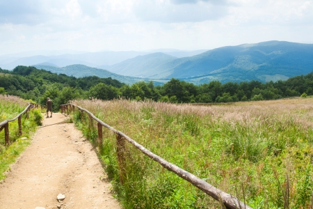 Wolosate, Poland - July 19, 2013  Two tourists photographing their self on the Bieszczady mountains background walking trail to the highest peak Tarnicaのeditorial素材