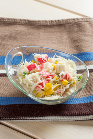 Crab sticks with rice noodles in glass bowl on textileの写真素材