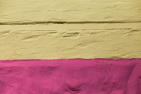 the structure of the plaster in yellow and pinkの写真素材