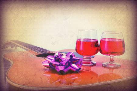 Grunge vintage Celebrate the day in the past with Folk Guitar and Two wine glassesの写真素材