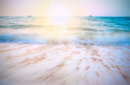 A view of a sandy beach Waves and beaches moving under sunlightの写真素材