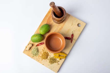 Mango Pickle setup with spice on wooden board