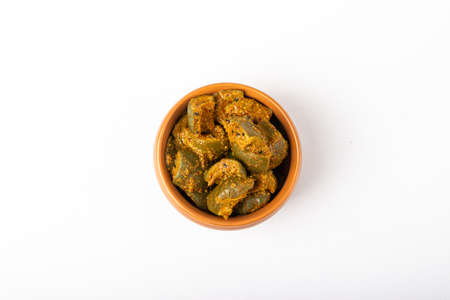 Mango Pickle in brown bowl in white backgroundの写真素材