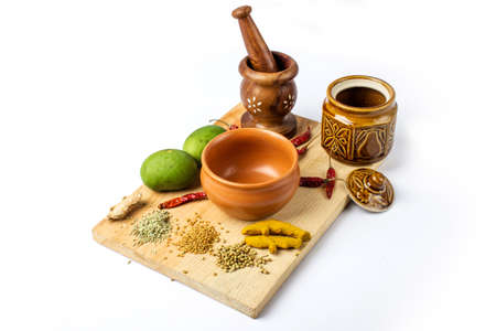 Mango Pickle setup with spice on wooden board
