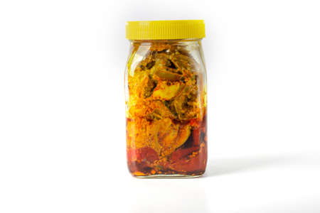 Mango Pickle jar with yellow cap on white backgroundの写真素材