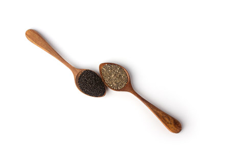Basil seeds and chia seeds in wooden spoonsの写真素材