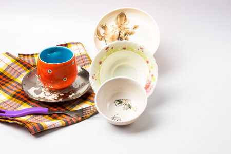 Modern tableware set with cutlery, glasses, and a vibrant blue plate, Trendy dinnerware on a tablecloth with copy spaceの写真素材
