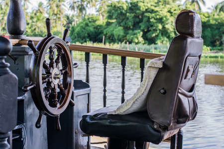 Boat driver's seat in the riverの写真素材