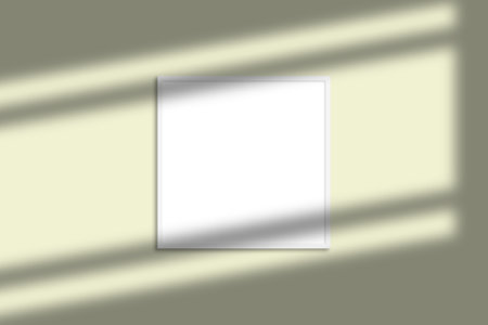 White square photo frame mockup with shadow overlay and pastel color backgroundの写真素材