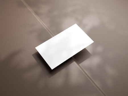 Closeup of empty white rectangle business card mockups lying diagonally on brown background. Flat lay, top view. Open composition. Blank Template for Corporate Identity. Copy space.の写真素材