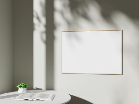 Empty framed canvas for mockups and art illustrations in minimalist room interiorの写真素材