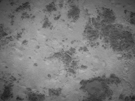 Rough cement texture with faded stains and cracks, creating a worn look.の写真素材