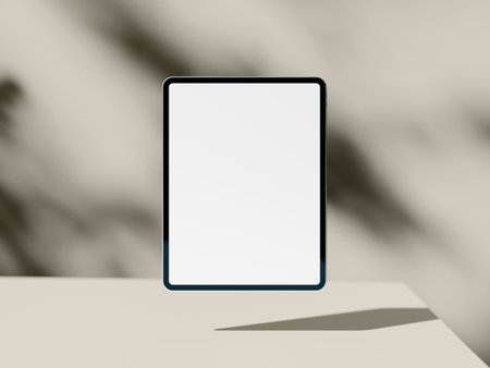 Minimal tablet screen mockup with shadow on beige abstract backgroundの写真素材