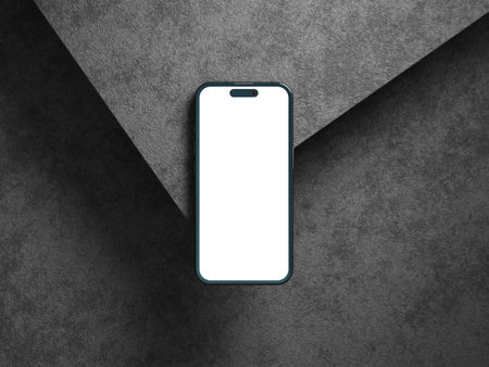 Blank phone screen on gray cement texture with shadows and depth.の写真素材