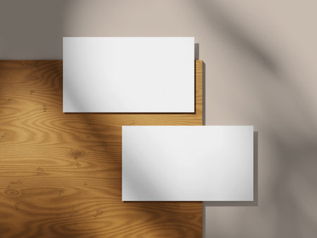 Simple business card mockup on a wood background with a smooth shadow effect.の写真素材