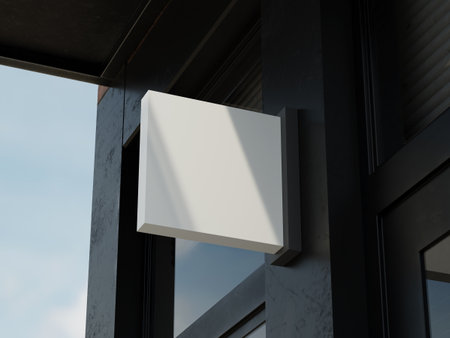 Sleek white hanging sign mockup attached to dark building cornerの写真素材
