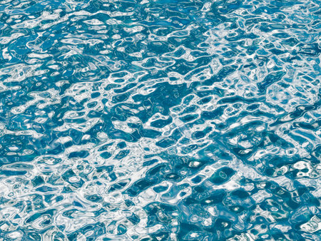 High contrast sparkling bright blue ocean water surface with white ripples