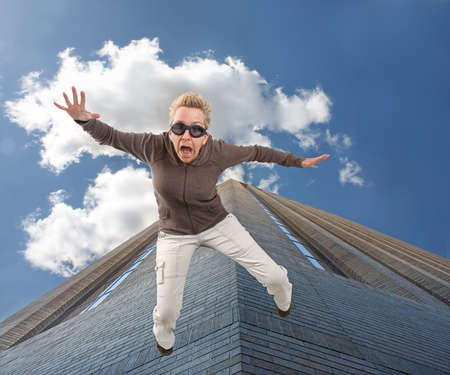 a woman falling off of a tall buildingの写真素材