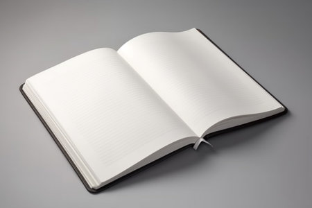 Blank open book on a gray background. Close-up.の素材