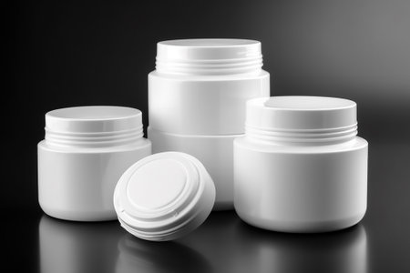 White plastic jars for cosmetics on a black background. 3d renderingの素材
