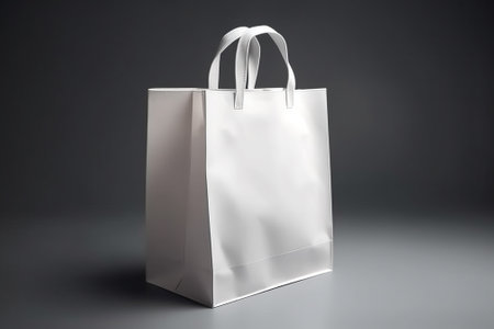 White paper shopping bag on a gray background. 3d rendering.の素材
