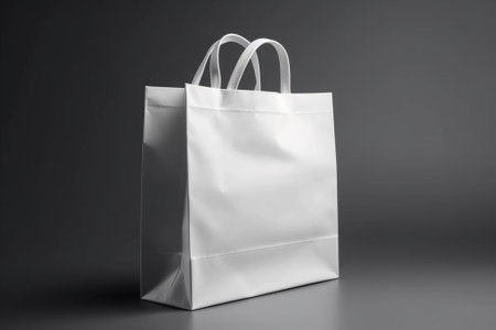 White paper shopping bag on grey background. Mock up, 3D Renderingの素材