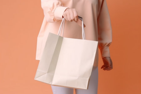Woman holding shopping bags on color background, closeup. Mockup for designの素材