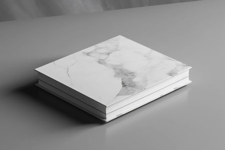White marble book on a gray background. Mockup for design.の素材