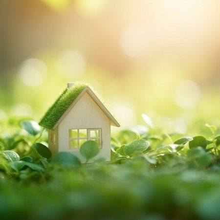 Miniature wooden house on green grass with sunlight background. Real estate concept.の素材