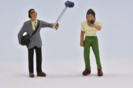 miniature people film crew is taking an interview scale 1:87の写真素材
