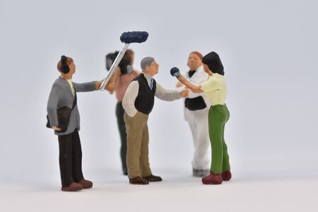 miniature people film crew is taking an interview scale 1:87の写真素材