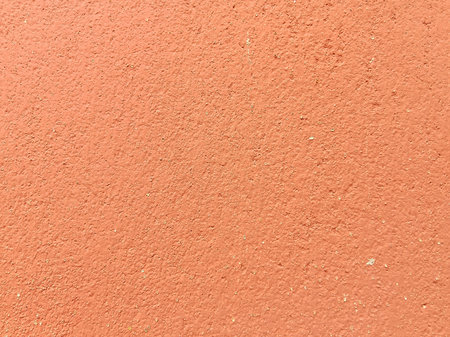 Orange concrete wall texture. Background and texture for design with copy space.の写真素材